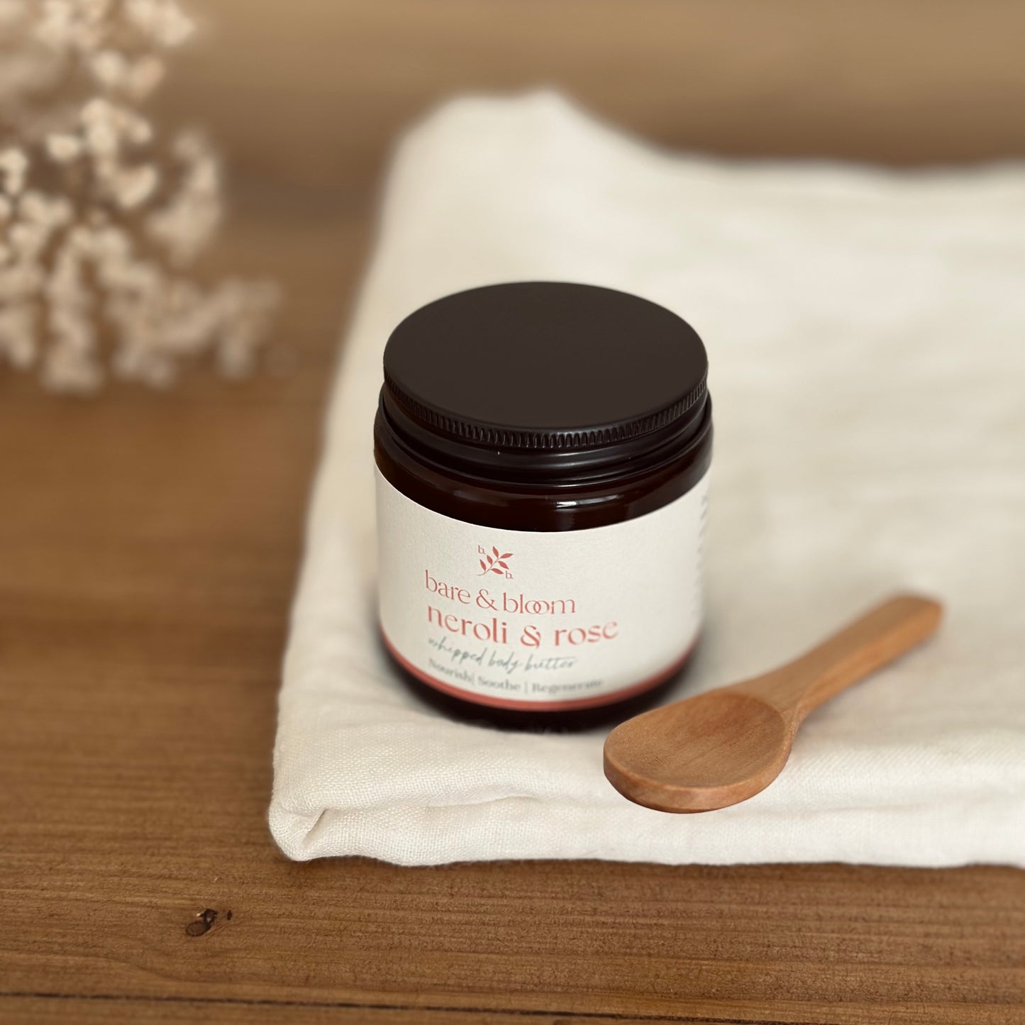 natural vegan body butter in amber jar on white cloth