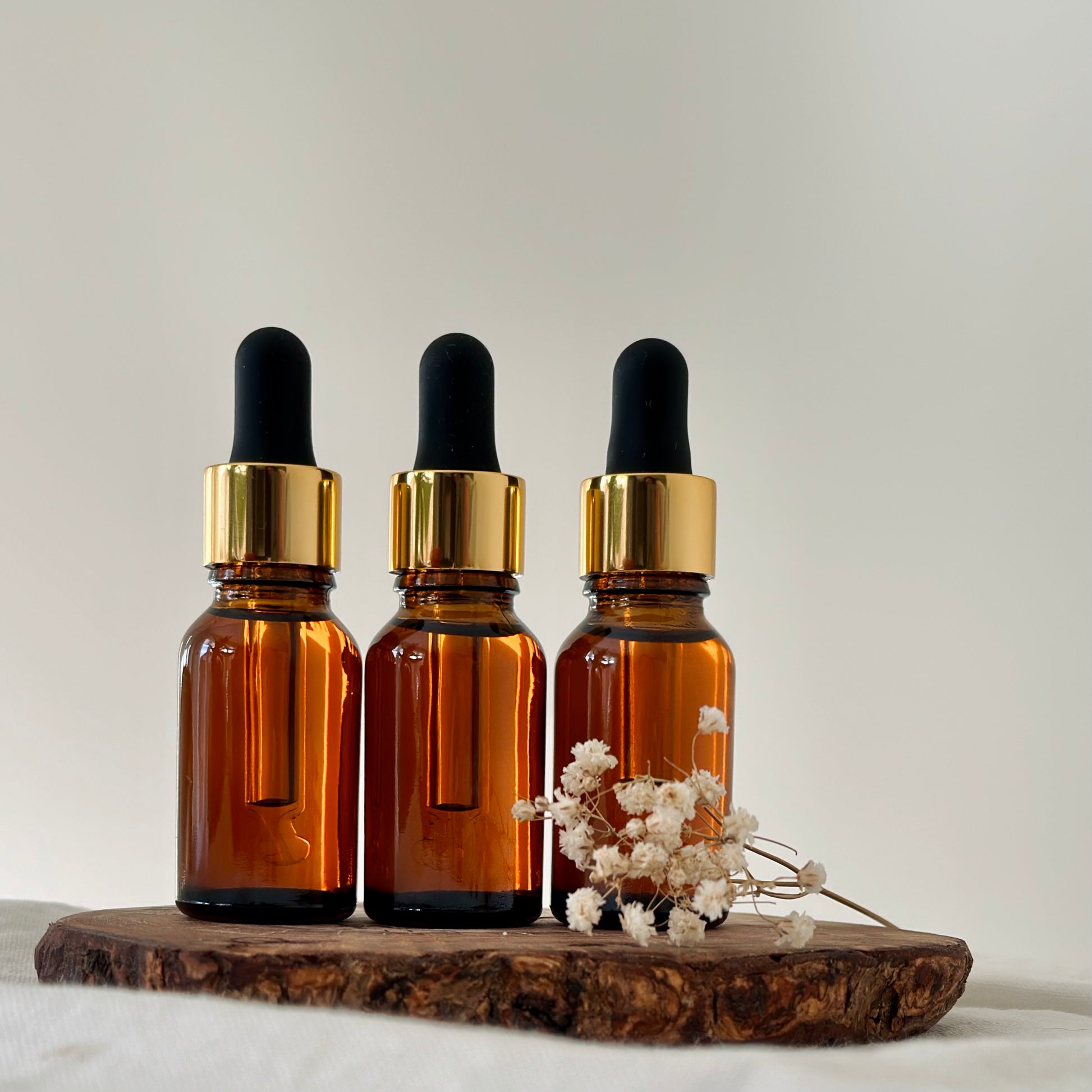 3 small face oils in amber jars