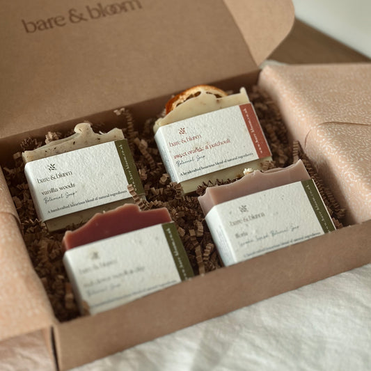 a box of 4 assorted artisan soaps in a kraft box with seeded paper labels