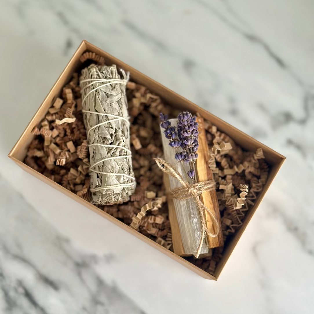 Two smudge sticks in a decorative box on a marble surface