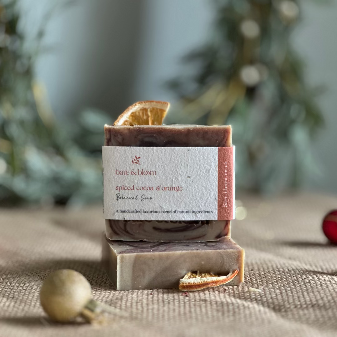 Seasonal bar of soap with a seeded label on a textured surface with a blurred green background