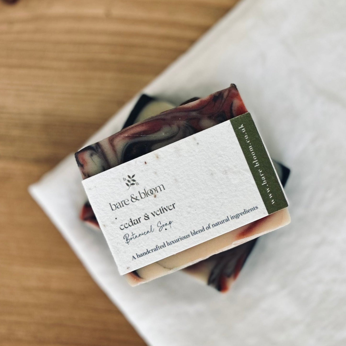artisan soap bar wrapped in seeded paper label