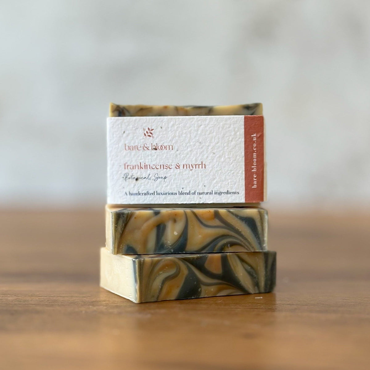 Frankincense and Myrrh botanical soap, three swirled bars stacked with the bare & bloom plantable seeded label